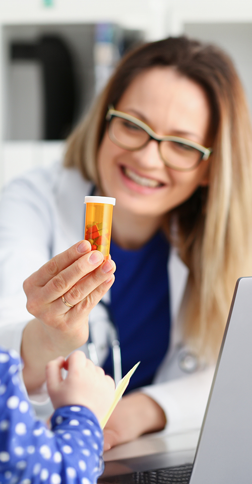 A doctor educates a child about medication safety